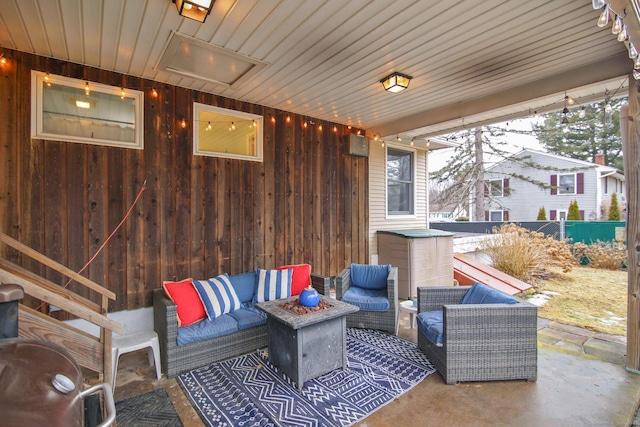 view of patio featuring an outdoor living space and fence