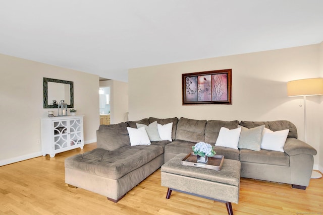 living area with baseboards and light wood-style flooring