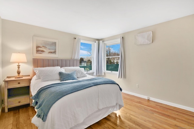 bedroom featuring baseboards and wood finished floors