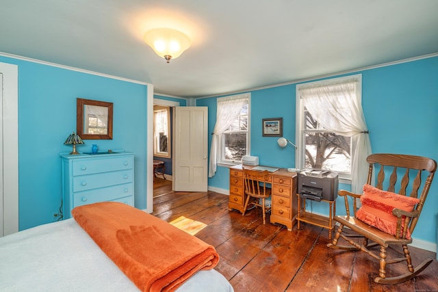 bedroom with crown molding, baseboards, and hardwood / wood-style floors