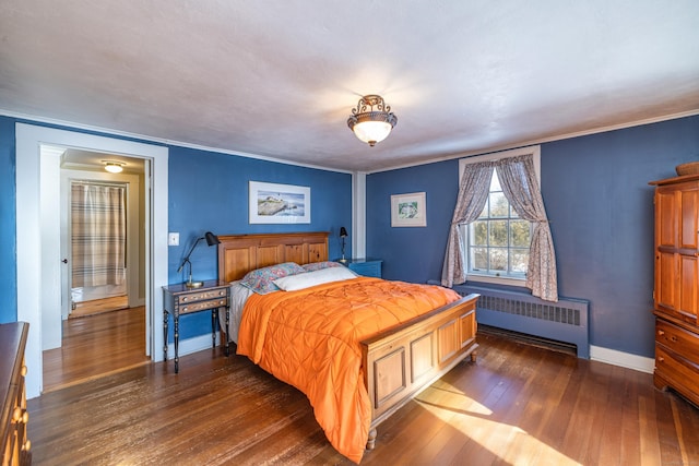 bedroom with baseboards, dark wood finished floors, and radiator heating unit