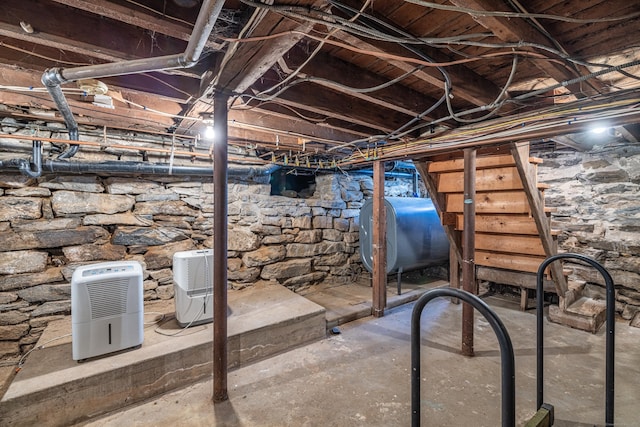 unfinished basement with stairs and heating fuel