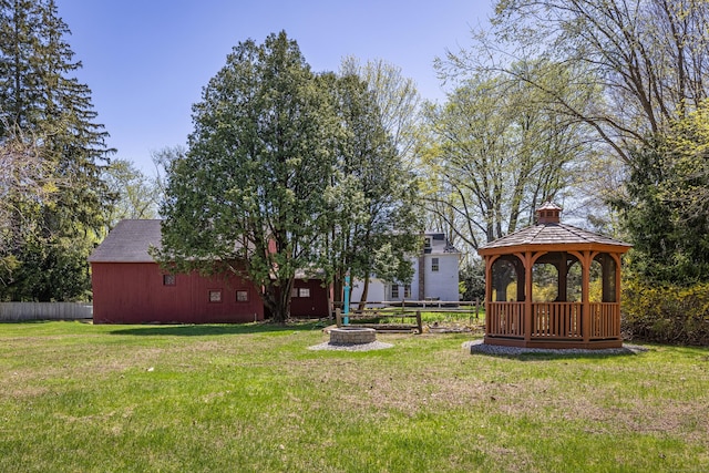 view of yard with a gazebo, a fire pit, and fence