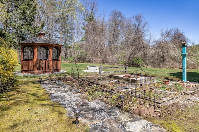 view of yard featuring a gazebo and a garden