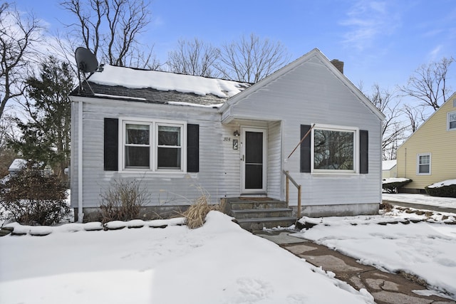 bungalow featuring a chimney