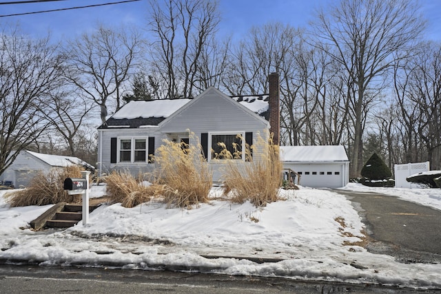 view of front facade featuring an outbuilding and a chimney