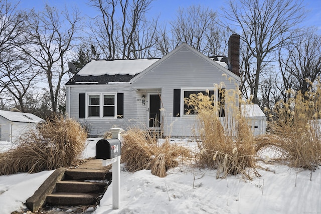 bungalow-style house with a chimney