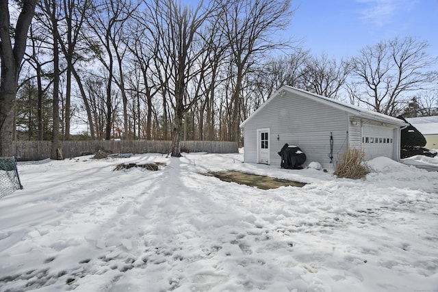 view of snowy exterior featuring a garage