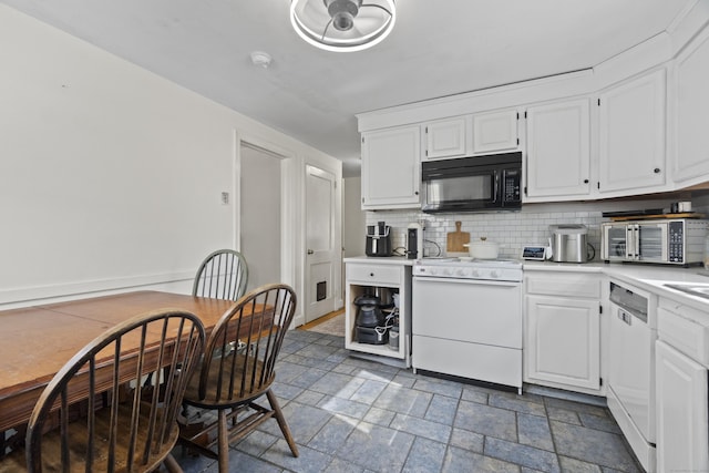 kitchen with white appliances, white cabinetry, light countertops, and stone tile flooring