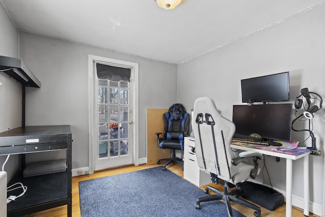 office with light wood-style floors and baseboards