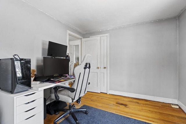 office area with baseboards and wood finished floors