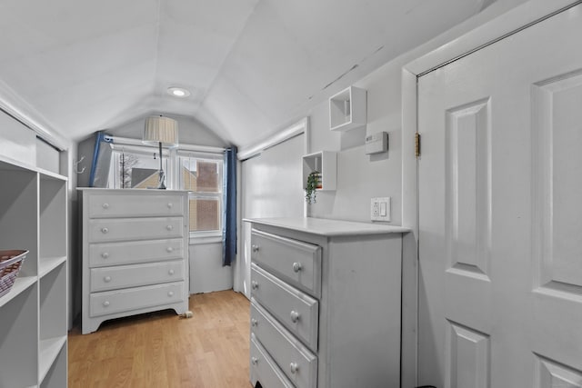 walk in closet featuring vaulted ceiling and light wood-style floors