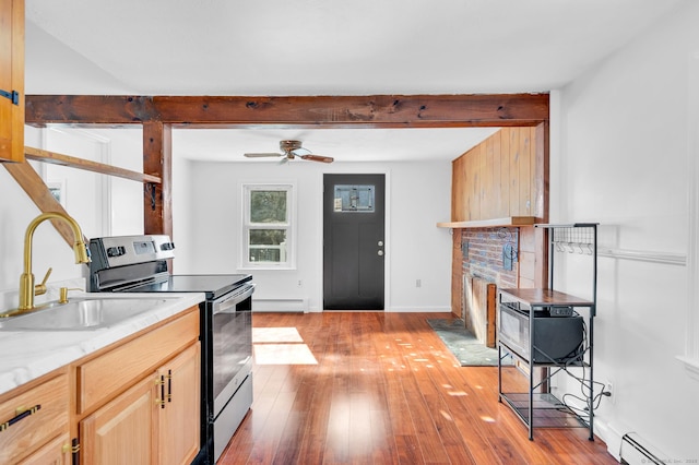 kitchen featuring electric range, beamed ceiling, light wood-style flooring, a sink, and a baseboard heating unit