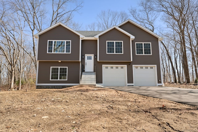 split foyer home featuring an attached garage and driveway