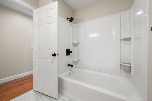 full bath with marble finish floor, shower / tub combination, and baseboards