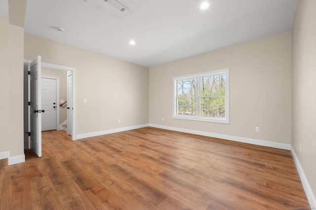 unfurnished bedroom with recessed lighting, baseboards, and light wood-style floors