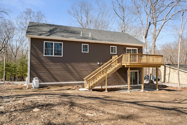 back of property featuring a deck and stairway