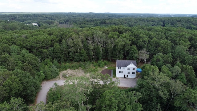 aerial view featuring a wooded view