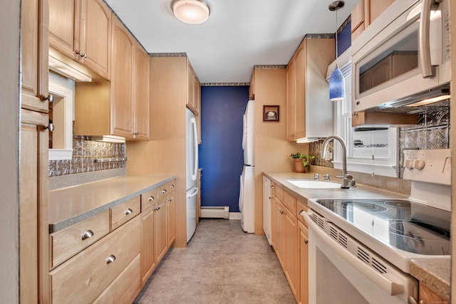 kitchen with decorative light fixtures, light countertops, light brown cabinets, a sink, and white appliances