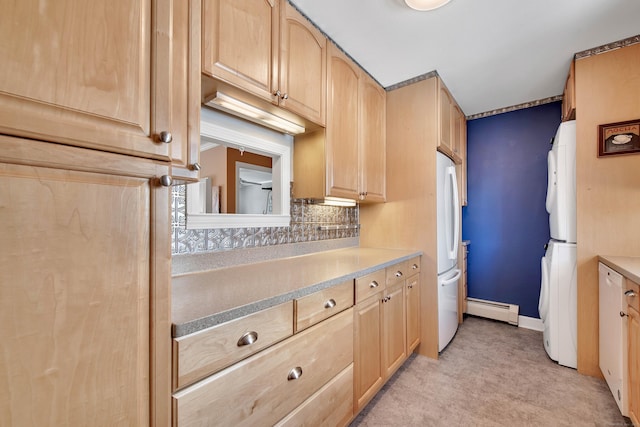 kitchen featuring a baseboard heating unit, freestanding refrigerator, light countertops, and light brown cabinets