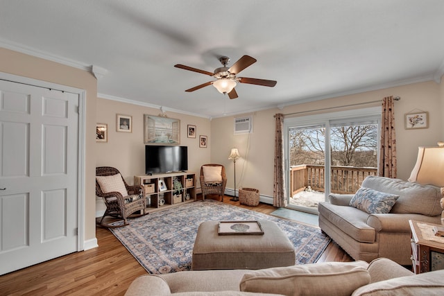 living area featuring ceiling fan, a baseboard heating unit, ornamental molding, and light wood-style flooring