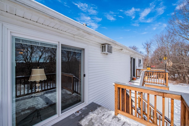 snow covered deck featuring a wall mounted AC