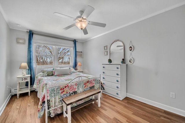 bedroom featuring baseboards, a ceiling fan, ornamental molding, wood finished floors, and a wall mounted AC