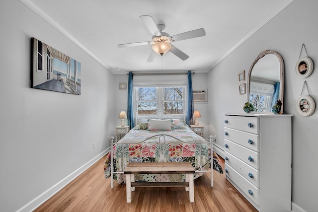 bedroom featuring a ceiling fan, baseboards, ornamental molding, light wood finished floors, and a wall mounted air conditioner