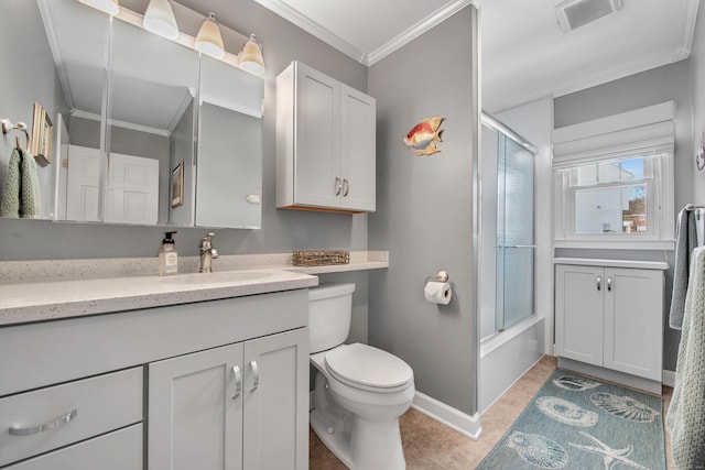 bathroom with tile patterned flooring, vanity, visible vents, combined bath / shower with glass door, and ornamental molding