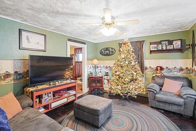 living room with a textured ceiling, ceiling fan, and dark wood-style flooring