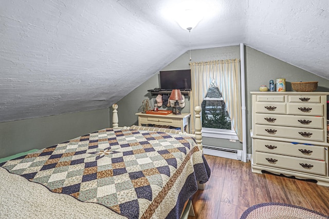 bedroom with a textured ceiling, dark wood-type flooring, baseboard heating, and vaulted ceiling