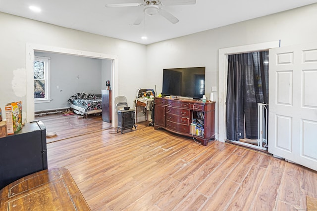 living room featuring light wood-type flooring, ceiling fan, and recessed lighting