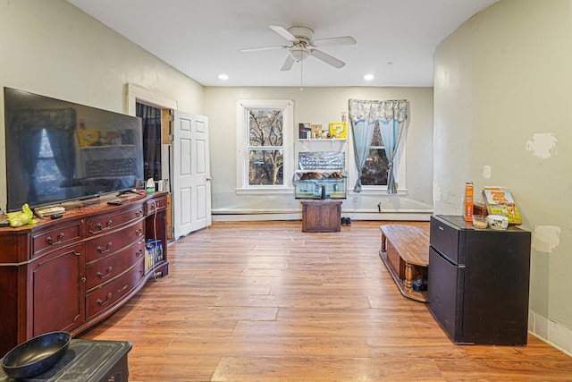 interior space featuring light wood finished floors, baseboard heating, and recessed lighting