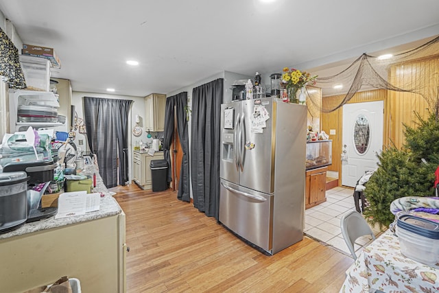 kitchen featuring light wood finished floors, recessed lighting, light countertops, and stainless steel fridge with ice dispenser