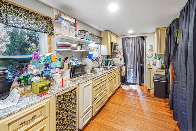 kitchen featuring open shelves, recessed lighting, light wood-style flooring, appliances with stainless steel finishes, and a sink