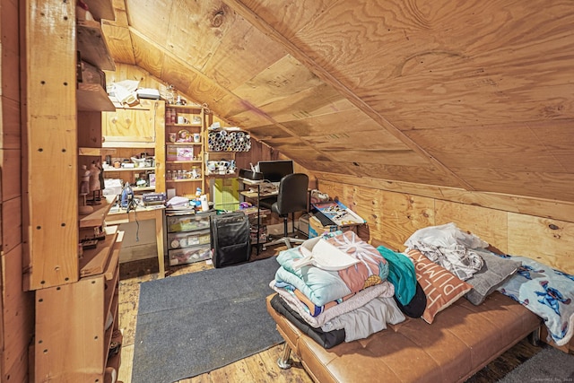 interior space featuring lofted ceiling, wood finished floors, wood ceiling, and wooden walls