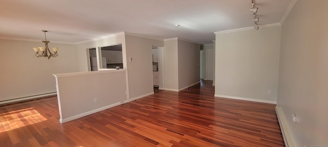 unfurnished room featuring an inviting chandelier, crown molding, baseboards, and wood finished floors