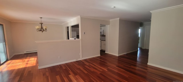 unfurnished room with dark wood-style floors, crown molding, baseboards, and a notable chandelier