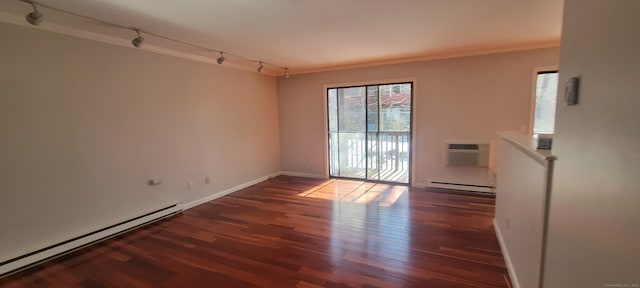 unfurnished room featuring a baseboard heating unit, ornamental molding, dark wood-type flooring, and a wall mounted AC