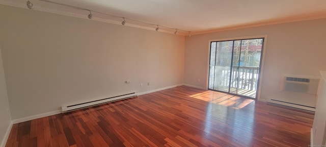 unfurnished room with a baseboard radiator, a wall mounted AC, and wood finished floors