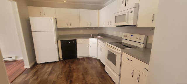 kitchen featuring dark countertops, white appliances, white cabinetry, and a sink