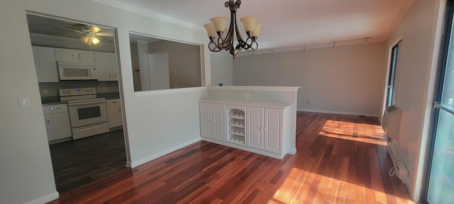 dining room with dark wood finished floors, baseboards, and an inviting chandelier