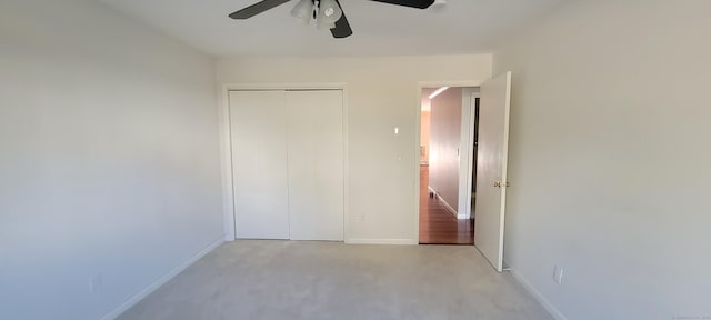 unfurnished bedroom with a ceiling fan, a closet, and baseboards