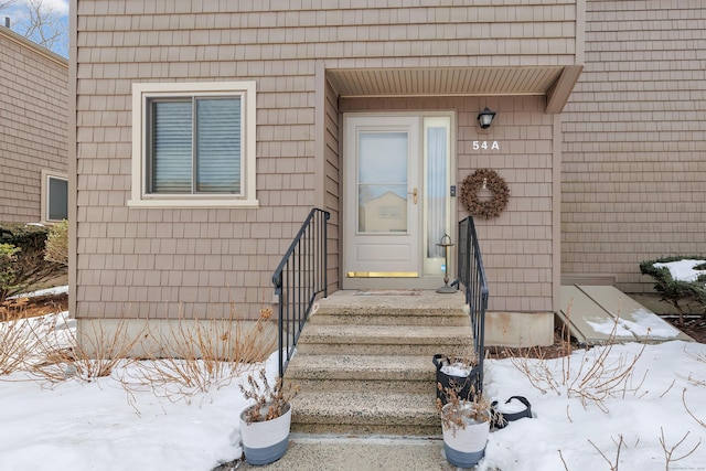 view of snow covered property entrance