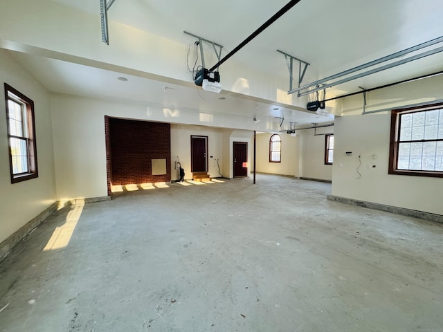 garage with a garage door opener and baseboards