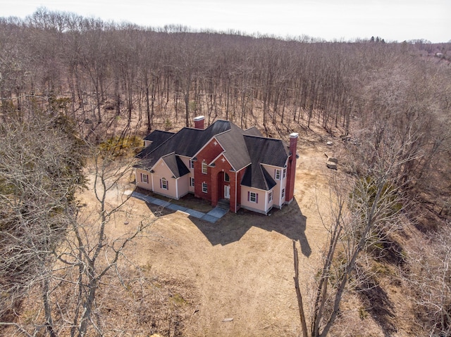 drone / aerial view featuring a wooded view