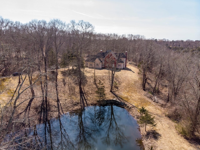 birds eye view of property featuring a view of trees