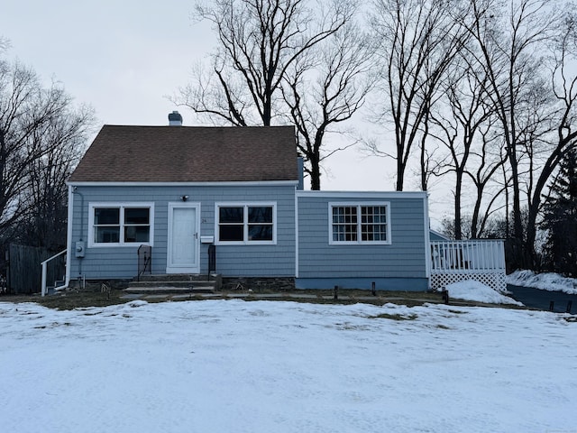 view of front of property featuring a shingled roof and a chimney