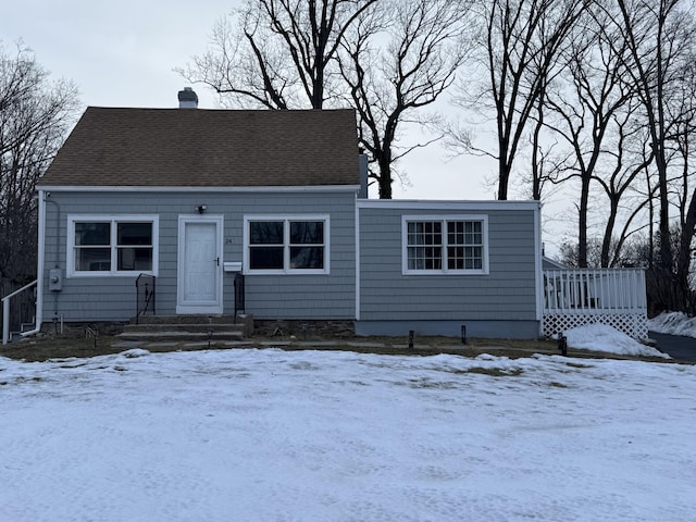 view of front of house featuring roof with shingles and a chimney