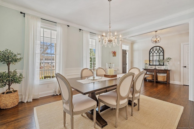 dining area with an inviting chandelier, ornamental molding, and dark wood finished floors